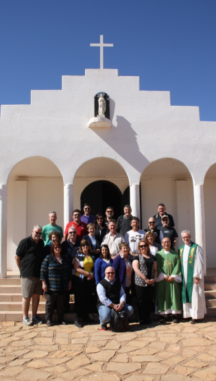 Group photo in front of the church at the Santa Teresa Mission after mass with the community.