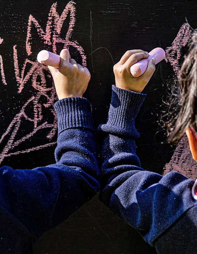 Students writing on blackboard at Mother Teresa Catholic Primary School Westmead