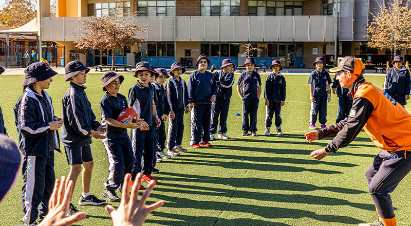 Students in midst of sport lesson at Mother Teresa Catholic Primary School Westmead