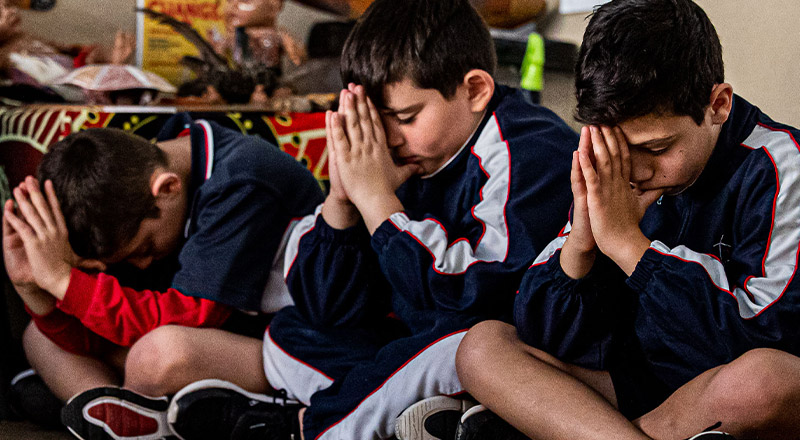Students praying at Mother Teresa Catholic Primary School Westmead