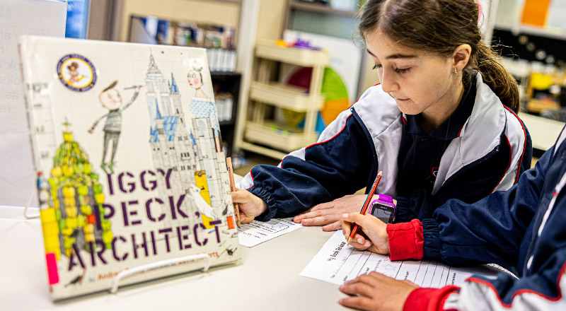 Student looking at book at Mother Teresa Catholic Primary School Westmead