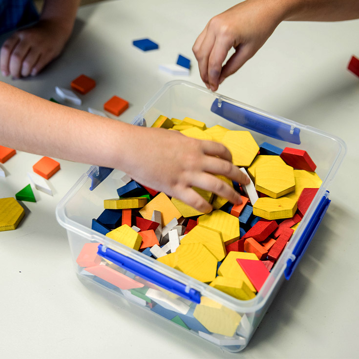 Close up shot of children holding plastic shapes at Mother Teresa Catholic Primary School Westmead