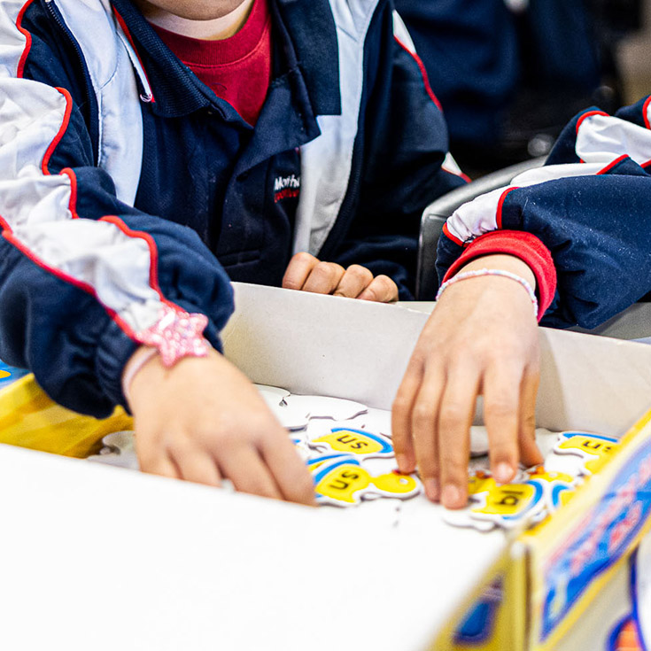 Children reaching into box at Mother Teresa Catholic Primary School Westmead