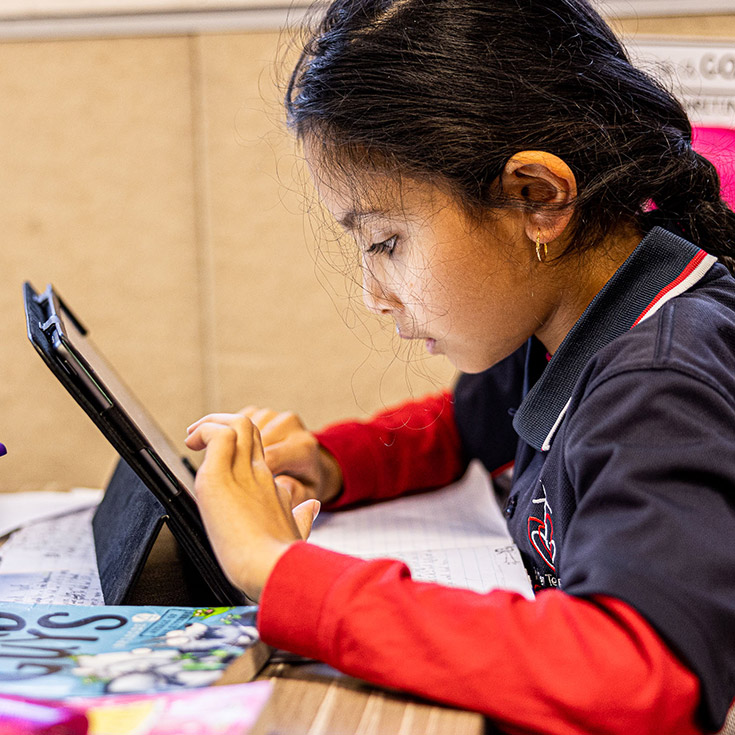Student on iPad at Mother Teresa Catholic Primary School Westmead