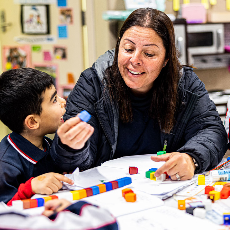 Dedicated teacher and student playing with toy blocks at Mother Teresa Catholic Primary School Westmead